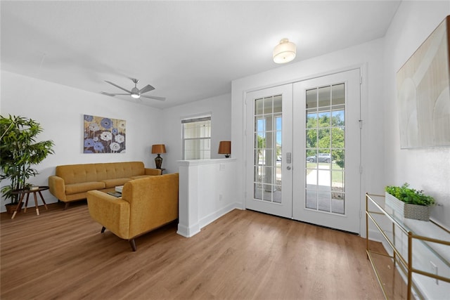 interior space with ceiling fan, french doors, and wood-type flooring