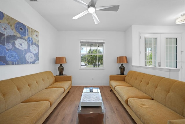 living room with hardwood / wood-style flooring and ceiling fan