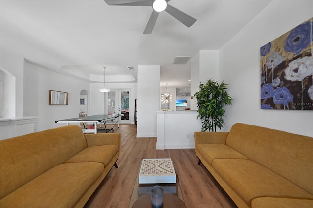 living room with hardwood / wood-style flooring and ceiling fan