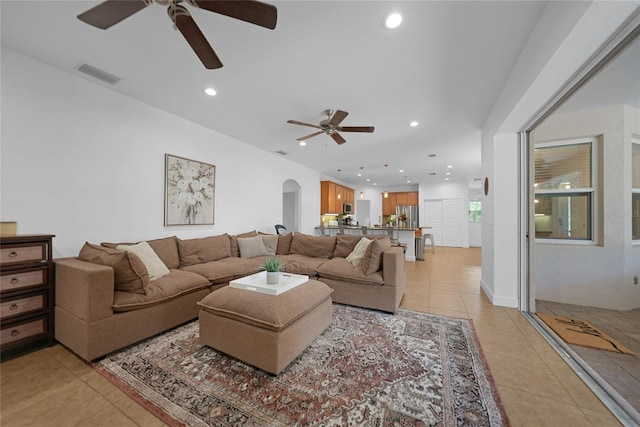 living room featuring ceiling fan and light tile patterned floors