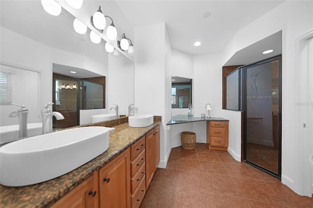 bathroom featuring tile patterned floors, a shower with door, and vanity