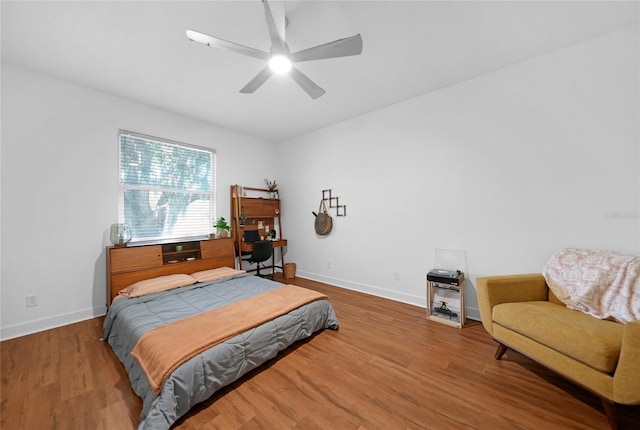 bedroom with ceiling fan and hardwood / wood-style flooring