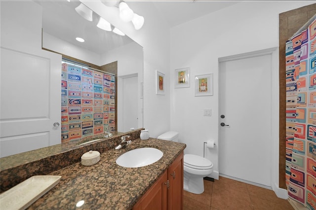 bathroom featuring tile patterned floors, vanity, and toilet