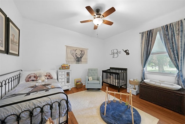 bedroom with ceiling fan and hardwood / wood-style floors