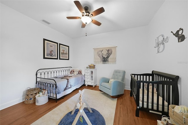 bedroom featuring hardwood / wood-style floors and ceiling fan