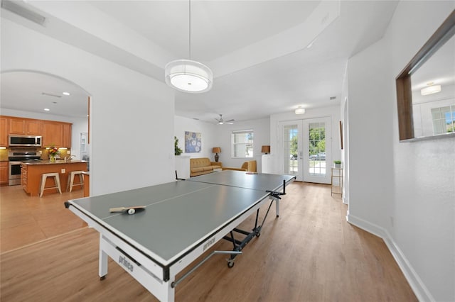 rec room featuring ceiling fan, french doors, and light hardwood / wood-style floors