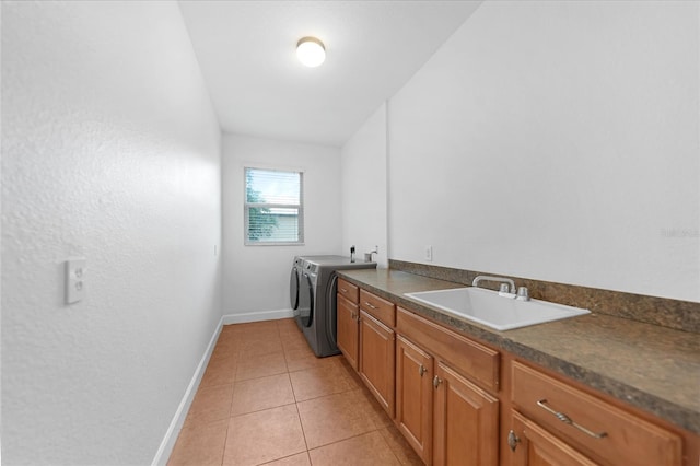 laundry room featuring cabinets, independent washer and dryer, light tile patterned floors, and sink