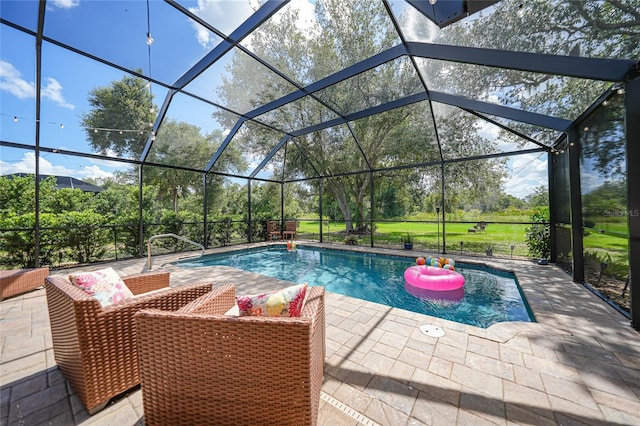 view of pool with glass enclosure and a patio