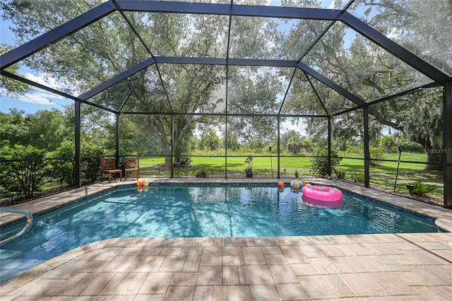 view of swimming pool featuring a lanai and a patio area