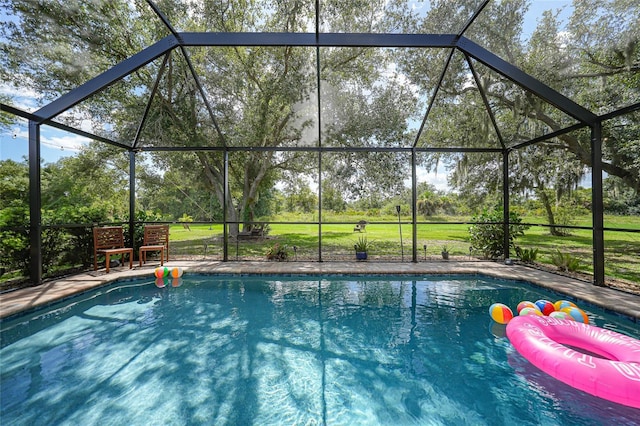 view of swimming pool featuring a lanai