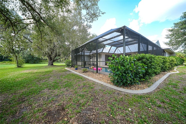 view of yard with glass enclosure