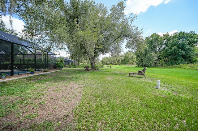 view of yard with glass enclosure