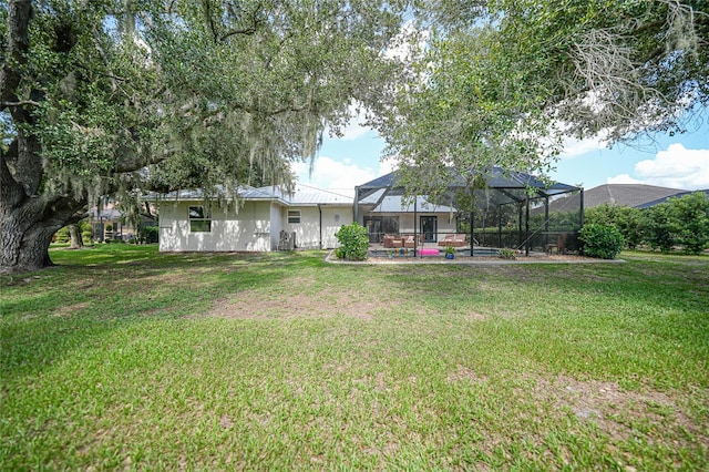 view of yard featuring glass enclosure and a swimming pool