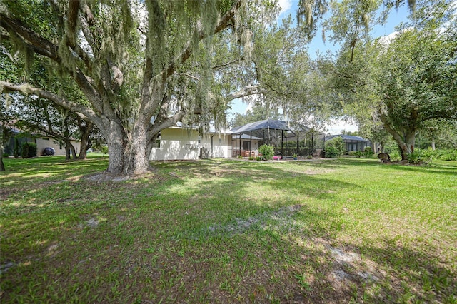 view of yard featuring a lanai