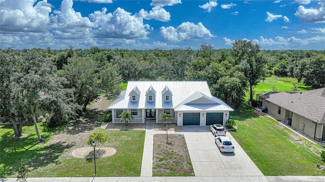 view of front of house featuring a front lawn, a porch, and a garage