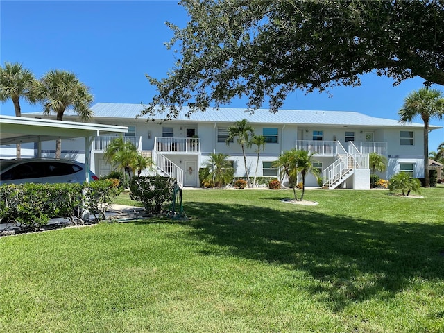 exterior space with a carport and a front yard