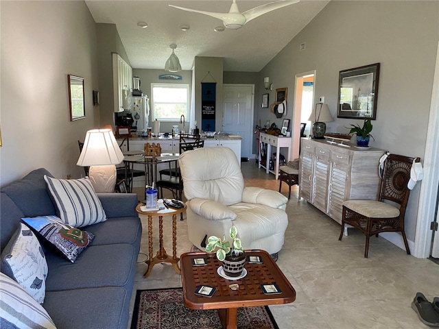 tiled living room featuring vaulted ceiling and ceiling fan