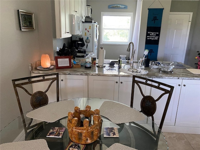 kitchen featuring white cabinets, white appliances, and sink