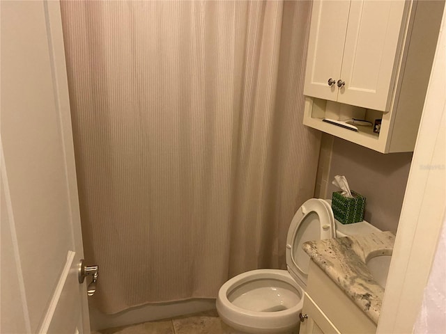 bathroom with tile patterned flooring, toilet, and vanity