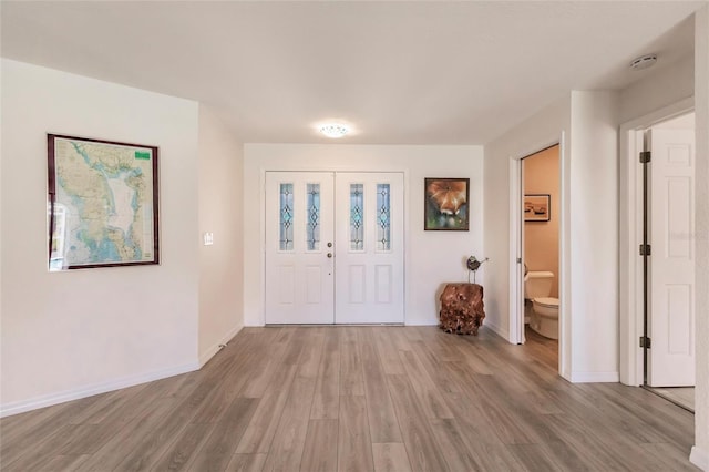 foyer entrance with light wood-type flooring