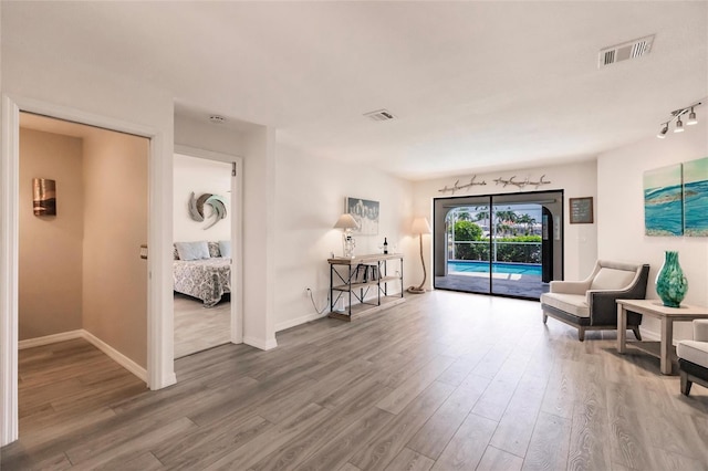 living area with hardwood / wood-style flooring