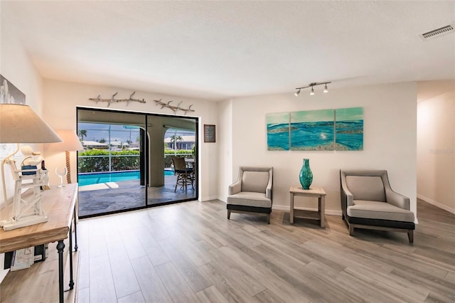 living area with light hardwood / wood-style floors