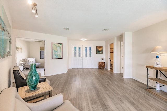 living area with light hardwood / wood-style flooring and ceiling fan