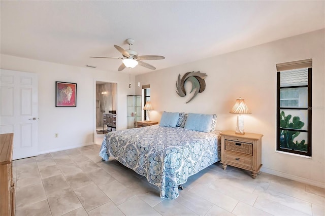 bedroom with ceiling fan and connected bathroom