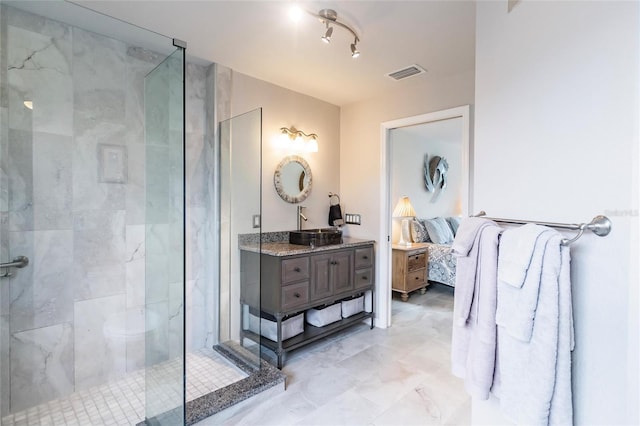 bathroom featuring vanity and a shower with door