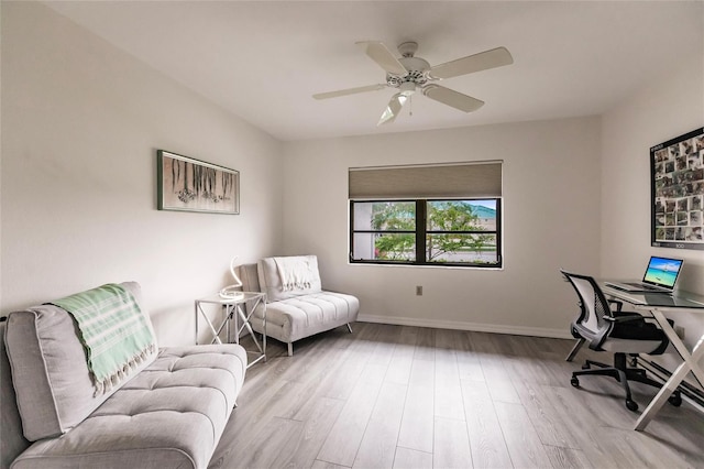 home office with ceiling fan and light hardwood / wood-style flooring