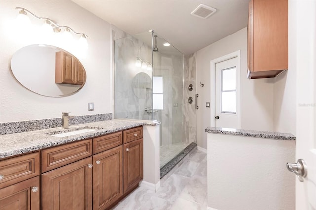 bathroom featuring vanity and a shower with door