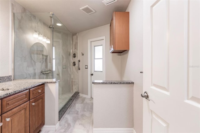 bathroom featuring vanity and a shower with door