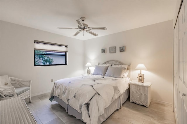 bedroom with light tile patterned floors, a closet, and ceiling fan