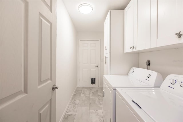 laundry room featuring cabinets and washing machine and dryer