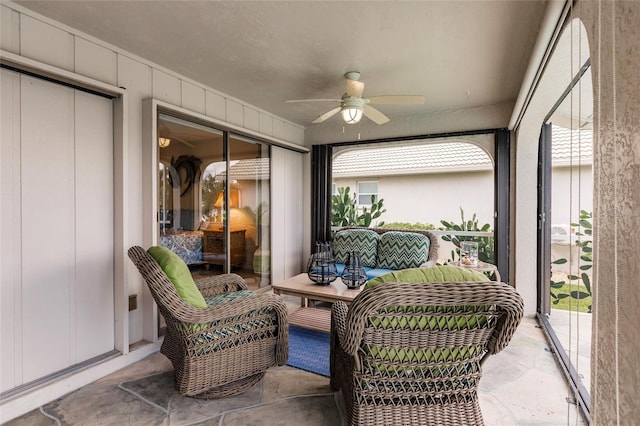 sunroom with ceiling fan and plenty of natural light