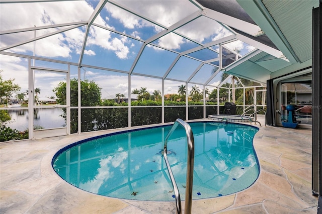 view of pool featuring a lanai, a patio area, a water view, and an in ground hot tub