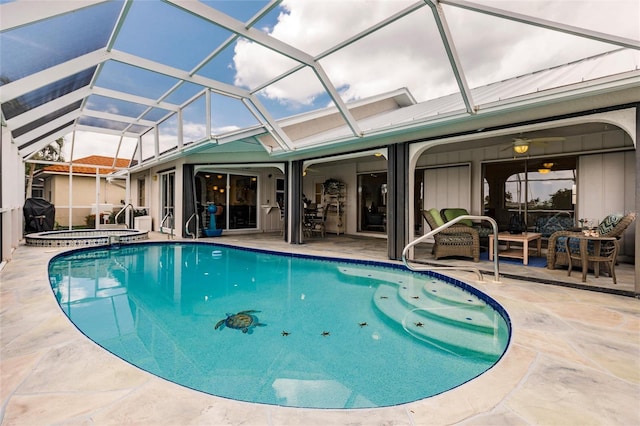 view of pool with an in ground hot tub, an outdoor living space, ceiling fan, glass enclosure, and a patio area