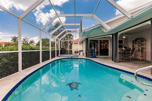 view of swimming pool featuring an in ground hot tub, a patio, and glass enclosure