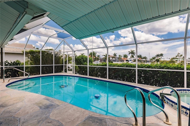 view of swimming pool with a patio and glass enclosure