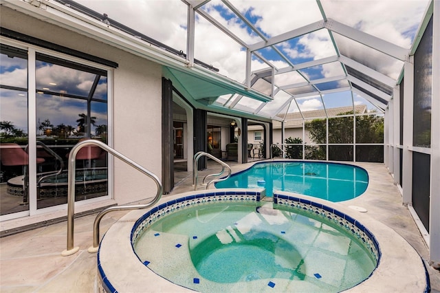 view of swimming pool featuring glass enclosure, an in ground hot tub, and a patio