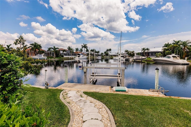 dock area featuring a water view and a lawn