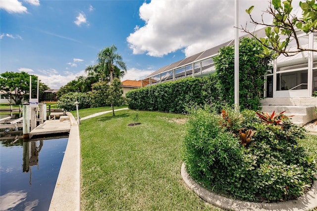 view of yard featuring a boat dock and a water view