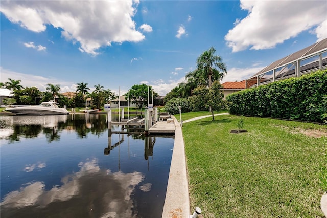 dock area with a water view and a lawn