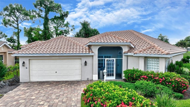 mediterranean / spanish-style home with a garage