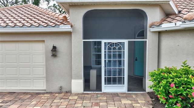 view of exterior entry featuring a garage