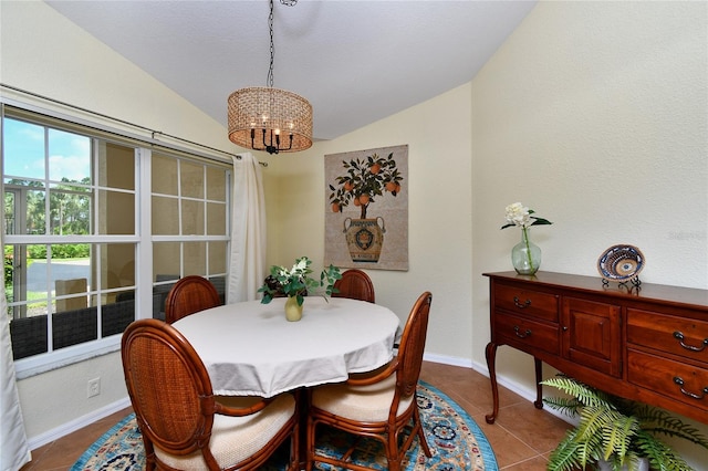 dining area with lofted ceiling, tile patterned floors, and a chandelier