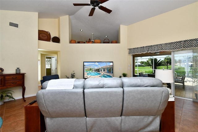 tiled living room featuring high vaulted ceiling and ceiling fan