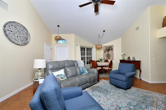 tiled living room with ceiling fan and high vaulted ceiling