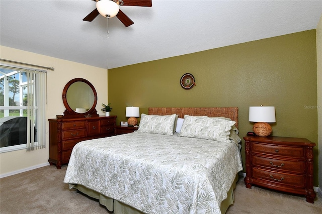 bedroom with ceiling fan, lofted ceiling, and light carpet