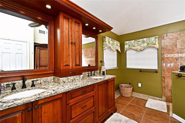 bathroom featuring tile patterned floors, vanity, and a textured ceiling